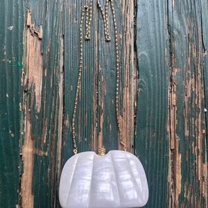 White plastic clutch bag with gold chain strap